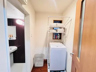 a small bathroom with a washer and dryer at LY-shinjuku-house SJ0432 in Tokyo