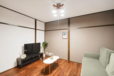 a living room with a couch and a tv at Kotori Hinoki in Tokyo