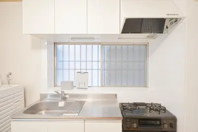 a kitchen with a stove and a sink and a window at Kotori Akasaka in Tokyo