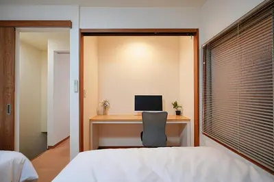 a bedroom with a desk with a computer on it at Kotori Akasaka in Tokyo