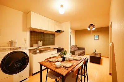 a kitchen with a wooden table and a dining room at Kotori Akasaka in Tokyo