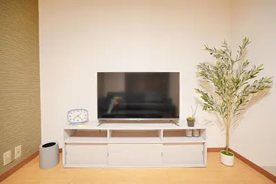 a living room with a tv on a white entertainment center at Kotori Akasaka in Tokyo