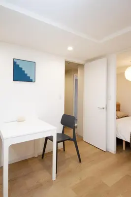 a white desk and a chair in a room with a bed at M House 301 Tokyo Omori\u99c5 in Tokyo