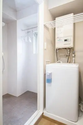 a bathroom with a white refrigerator and a shower at M House 301 Tokyo Omori\u99c5 in Tokyo