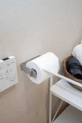 a roll of toilet paper hanging on a wall at M House 301 Tokyo Omori\u99c5 in Tokyo