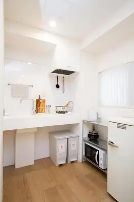 a white kitchen with a sink and a refrigerator at M House 301 Tokyo Omori\u99c5 in Tokyo