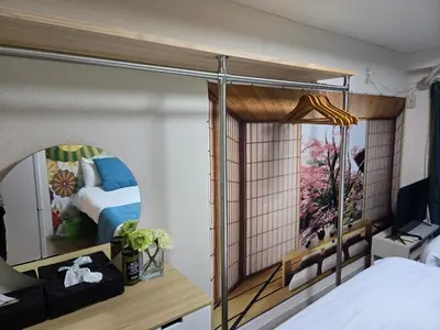 a room with a bedroom with a bed and a mirror at BandK Numabukuro 202 in Tokyo