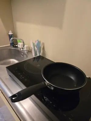 a pan sitting on top of a stove in a kitchen at BandK Numabukuro 202 in Tokyo