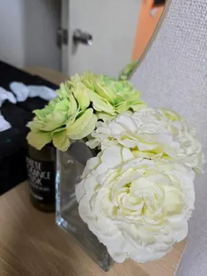 a vase filled with white flowers on a table at BandK Numabukuro 202 in Tokyo