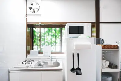 a white kitchen with a sink and a microwave at Monthly Only Kotori Hinoki Ideal Place for Long-term Stay and Workcation in Tokyo
