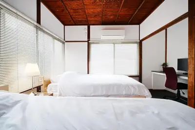 a bedroom with two beds and a desk with a computer at Monthly Only Kotori Hinoki Ideal Place for Long-term Stay and Workcation in Tokyo