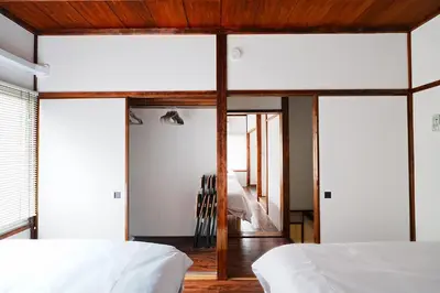 a bedroom with white walls and wooden ceilings at Monthly Only Kotori Hinoki Ideal Place for Long-term Stay and Workcation in Tokyo