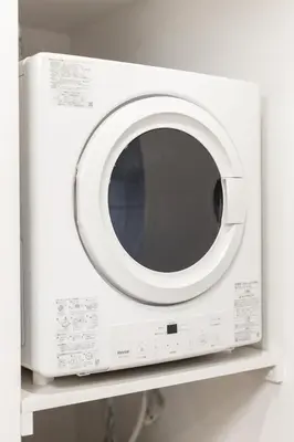 a white microwave oven sitting on a shelf at TaroTime Shinjuku Serene Japanese Cottage in Tokyo