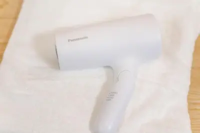 a white remote control sitting on top of a white towel at TaroTime Shinjuku Serene Japanese Cottage in Tokyo