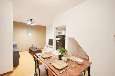 a dining room with a table and a kitchen at Monthly Only Kotori Akasaka Ideal Place for Long-term Stay and Workcation in Tokyo