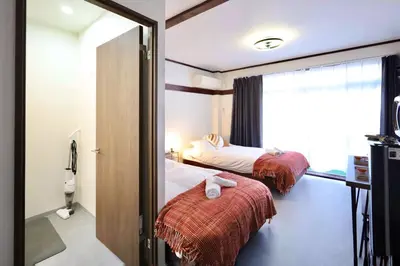a hotel room with two beds and a mirror at \u696d\u5e732\u968e3\u968e \u5c4b\u4e0a\u30b9\u30ab\u30a4\u30c4\u30ea\u30fc\u30d3\u30e5\u30fc \u6700\u59276\u540d in Tokyo