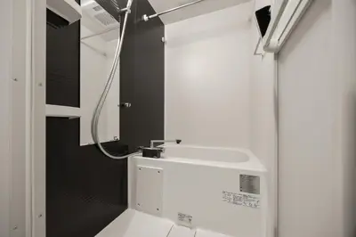 a bathroom with a white sink and a mirror at 4\u540d\u5bbf\u6cca \u897f\u65b0\u5bbf\u30a2\u30d1\u30fc\u30c8\u30e1\u30f3\u30c8 in Tokyo