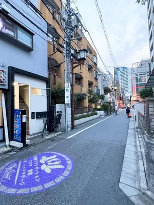 an empty city street with a purple sign on the road at Minamikoiwa, Edogawa City -3F-EG0477 in Tokyo