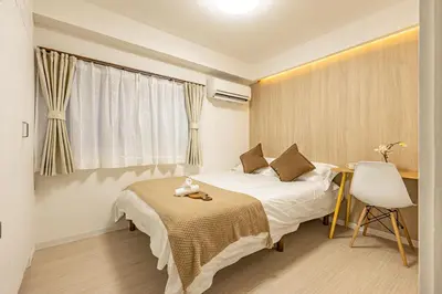 a bedroom with a bed and a desk and a window at SUNRISE STAY Ebisu in Tokyo