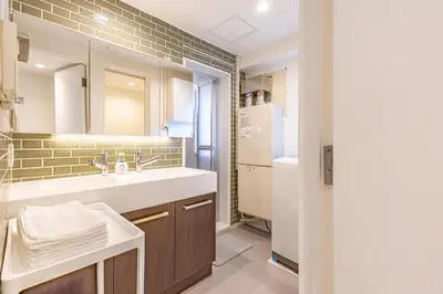 a bathroom with a sink and a refrigerator at SUNRISE STAY Ebisu in Tokyo