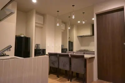 a kitchen with a bar with bar stools at AHAI \u30db\u30c6\u30eb2 - Tokyo Private VILLA in Tokyo