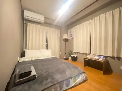 a bedroom with a bed with a phone on it at OK building - Vacation STAY 88201v in Tokyo