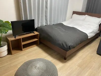 a bedroom with a bed with a television on a table at OK building - Vacation STAY 88217v in Tokyo