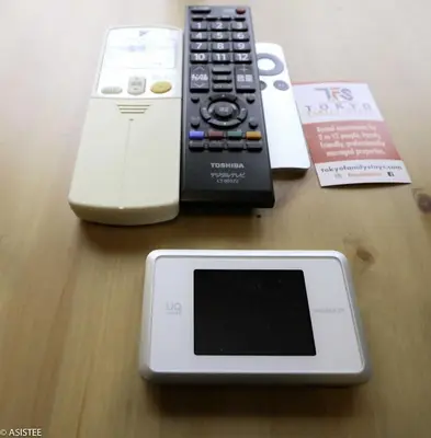 a table with a nintendo wii and a remote control at Corpo HARU 101 - Vacation STAY 23522v in Tokyo