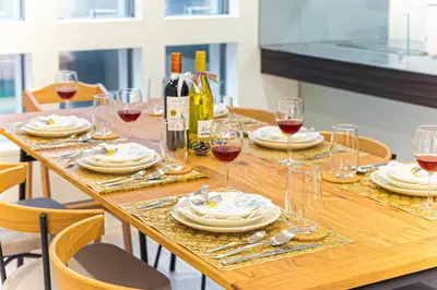 a wooden table with wine glasses and wine bottles at STARRY STAY HOUSE SHIBUYA I - Vacation STAY 65376v in Tokyo