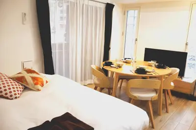 a bedroom with a bed and a table with chairs at Room 101 - Vacation STAY 82221v in Tokyo