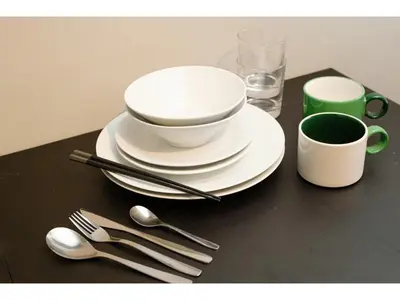 a table with white plates and spoons and a cup at Living Stay Plum Residence - Vacation STAY 20585 in Tokyo