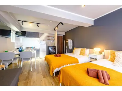 a hotel room with two beds and a kitchen at Living Stay Plum Residence - Vacation STAY 20586 in Tokyo