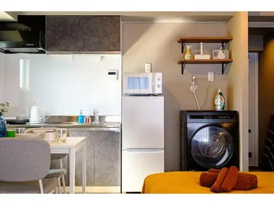 a kitchen with a washer and a washing machine at Living Stay Plum Residence - Vacation STAY 20586 in Tokyo