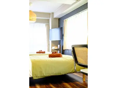 a bedroom with a bed and a chair at Living Stay Plum Residence - Vacation STAY 20584 in Tokyo