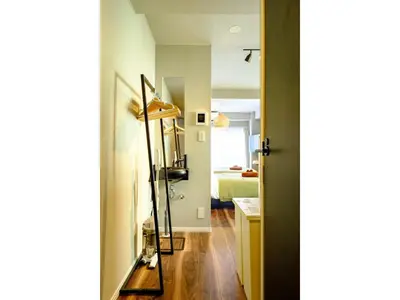 a hallway with a mirror and a room with a bed at Living Stay Plum Residence - Vacation STAY 20584 in Tokyo