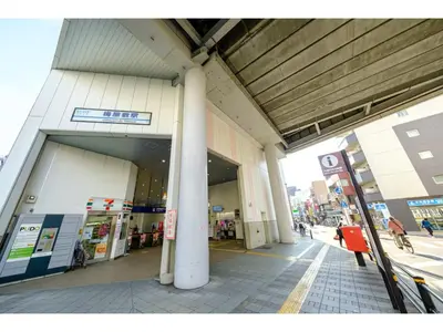 a building with a gas station on a city street at Living Stay Plum Residence - Vacation STAY 20584 in Tokyo
