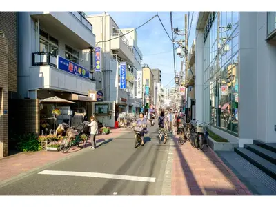a group of people riding bikes down a city street at Living Stay Plum Residence - Vacation STAY 20584 in Tokyo