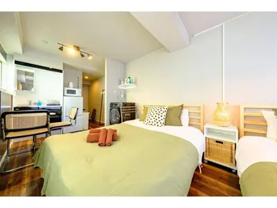 a bedroom with two beds and a living room at Living Stay Plum Residence - Vacation STAY 20584 in Tokyo