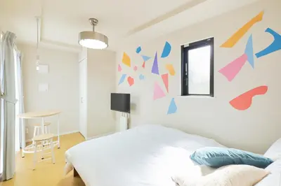a bedroom with a bed with a colorful wall at Ruygo Setagaya 201 - Vacation STAY 83657v in Tokyo