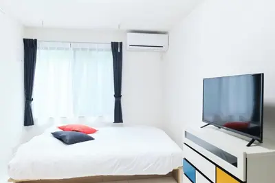 a bedroom with a bed and a flat screen tv at GRANQUAL Horikiri 101 - Vacation STAY 83799v in Tokyo
