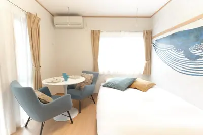 a bedroom with a bed and a table and chairs at Domire Setagaya - Vacation STAY 20604 in Tokyo