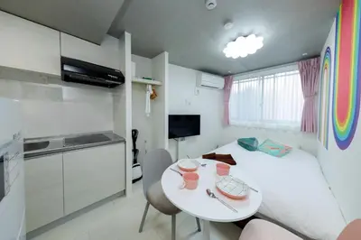 a small room with a white bed and a table at Reco Waseda - Vacation STAY 20609 in Tokyo