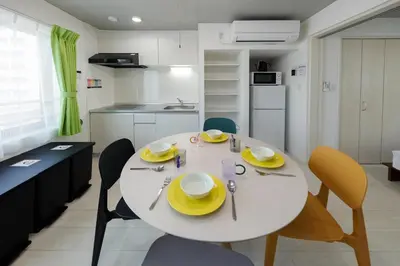 a white table with yellow plates and chairs in a kitchen at Reco Waseda - Vacation STAY 20620 in Tokyo