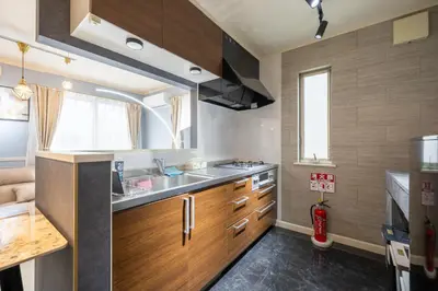 a kitchen with wooden cabinets and a sink at Familia Heiwajima 2 in Tokyo
