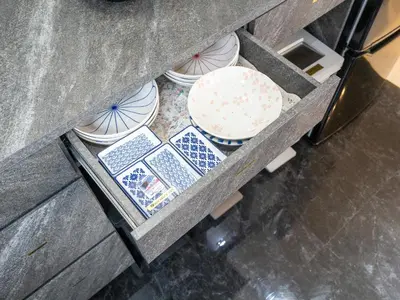 a shelf with bowls and plates on it at Familia Heiwajima 2 in Tokyo