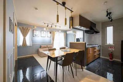 a kitchen and living room with a table and chairs at Familia Heiwajima 2 in Tokyo