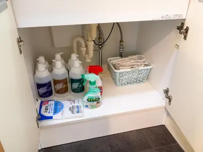 a cupboard with bottles of milk and other items at Familia Heiwajima 2 in Tokyo