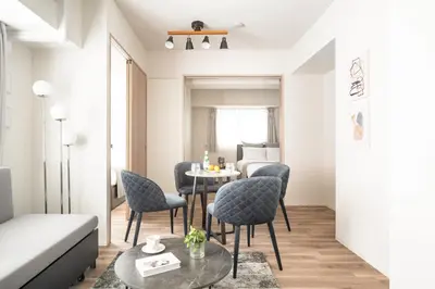 a living room with a table and chairs at ASMACi MAISON\u4e21\u56fd I in Tokyo