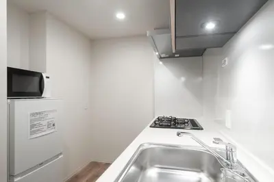 a small kitchen with a sink and a refrigerator at ASMACi MAISON\u4e21\u56fd I in Tokyo