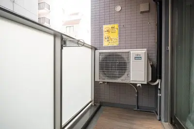 a bathroom with a fan in a wall at ASMACi MAISON\u4e21\u56fd I in Tokyo